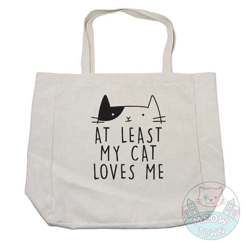 A lovely, funny tote bag printed in the UK by us at Meow Town, exclusively for You. 'At least my cat loves me’ slogan with a cute kitty print. Natural beige bag colour. Durable