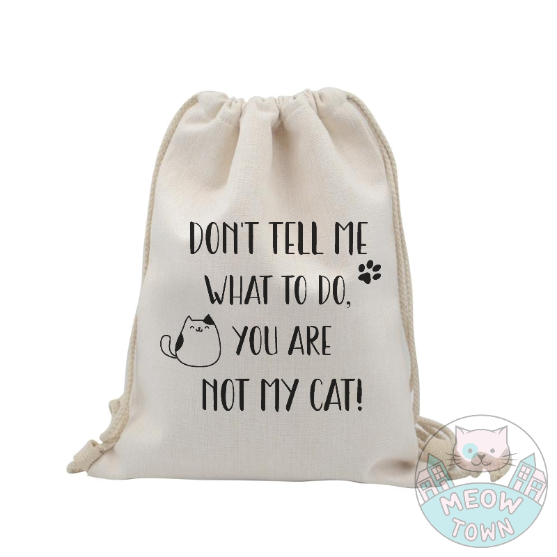 Funny and handy linen touch tote bag printed in the UK by us at Meow Town exclusively for You. 'Don’t tell me what to do, you are not my cat’ slogan with kitty and paw print. Natural beige bag colour. Durable