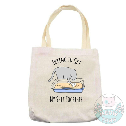 Super cute yet handy tote bag printed in the UK by us at Meow Town exclusively for You. Funny 'Trying to get my shit together’ quote with a kitty cleaning his own litter tray :) Natural beige colour. Durable single layer material. Polyester and cotton fabric, linen effect.  Choose from 3 bag types: Classic tote, Large tote or drawstring backpack.