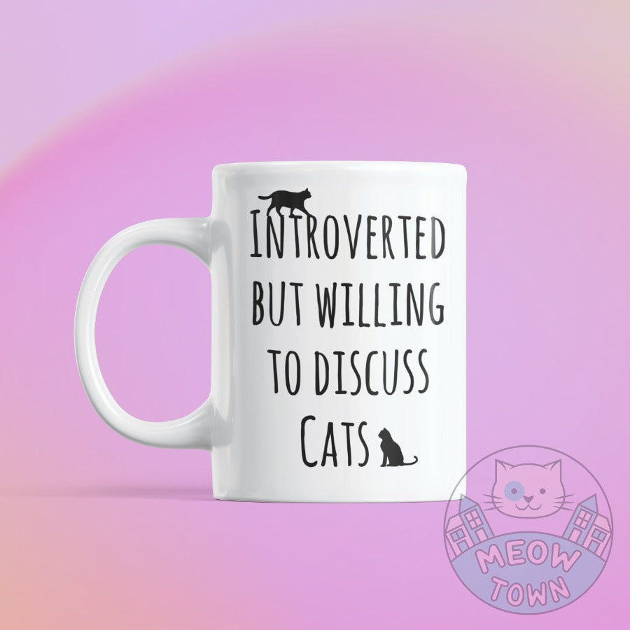 Funny 'Intorverted but willing to discuss cats' slogan ceramic mug, from our Meow Town Special collection. Printed exclusively for You in the UK in-house by us. Funny and unique present for your cat lover friends and family.