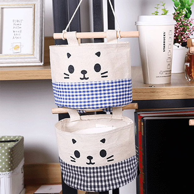 A super cute, small hanging storage bag with adorable printed kitty face to organise your everyday items in your kitchen, diy corner, office and so on. blue and black checked pants