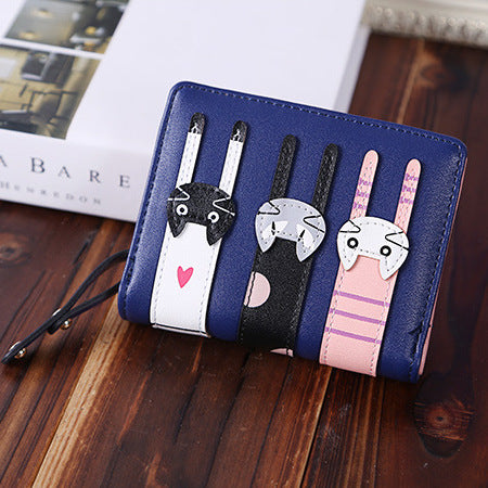 A beautiful and unique small purse with three adorable kitties. Features card holder sleeves and zip-around coin pocket.