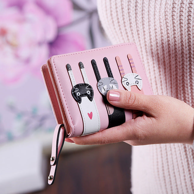 A beautiful and unique small purse with three adorable kitties. Features card holder sleeves and zip-around coin pocket. pink wallet for cat lovers