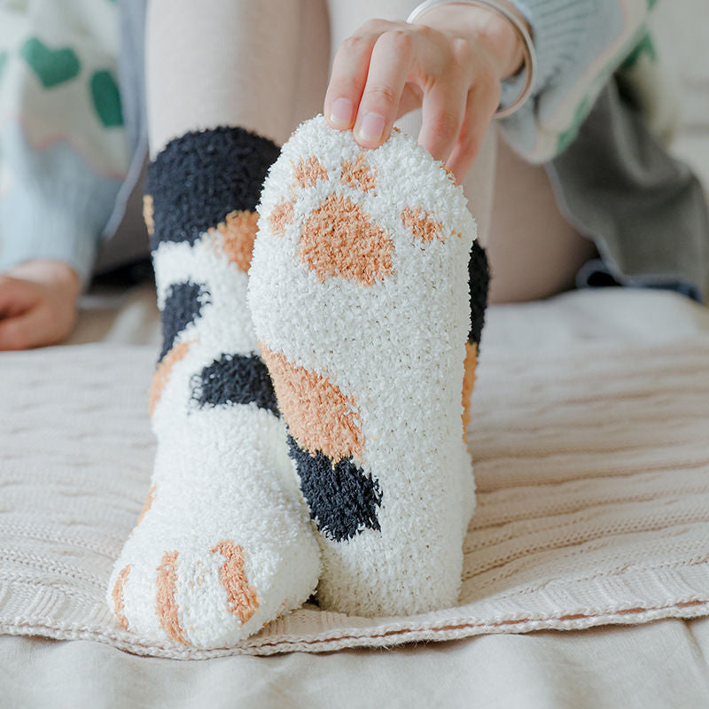 A pair of lovely, warm socks to match your footsies to your little furry friend's paws. Soft and very comfy. One size calico paw pattern
