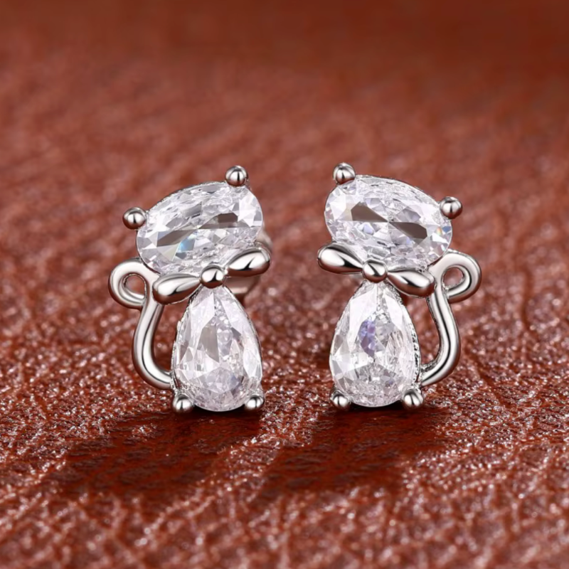 Crystal Cat With Bow Earrings on brown background