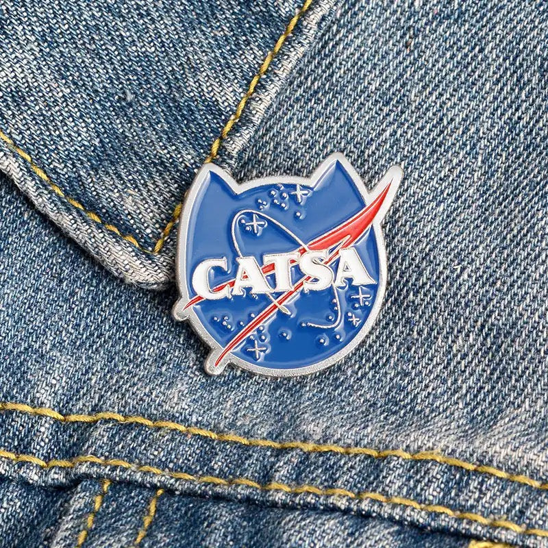 Cat pin badge for cat lovers. Funny NASA style ‘CATSA’ kitty shaped enamel pin badge.