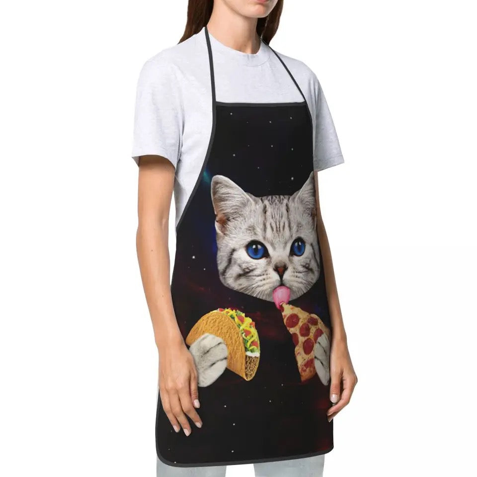 If you like cooking and baking, and you are a crazy cat lover, then a cat apron is a MUST have accessory for you.  This cute apron has a tabby kitty with pizza and taco print, on black background.