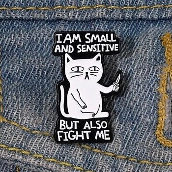 Funny enamel pin badge with ‘I am small and sensitive but also fight me’ slogan. Dimensions: 1 x 0.7 inch. Material: Enamel, zinc alloy. It can be a lovely little cheer me up gift for your friends, colleagues and family, or a purrfect stocking filler.
