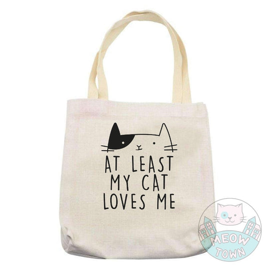A lovely, funny tote bag printed in the UK by us at Meow Town, exclusively for You. 'At least my cat loves me’ slogan with a cute kitty print. Natural beige bag colour. Durable