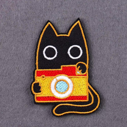 iron-on patch with black cat and camera