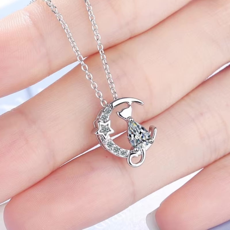 cat and moon pendant with crystals in hand