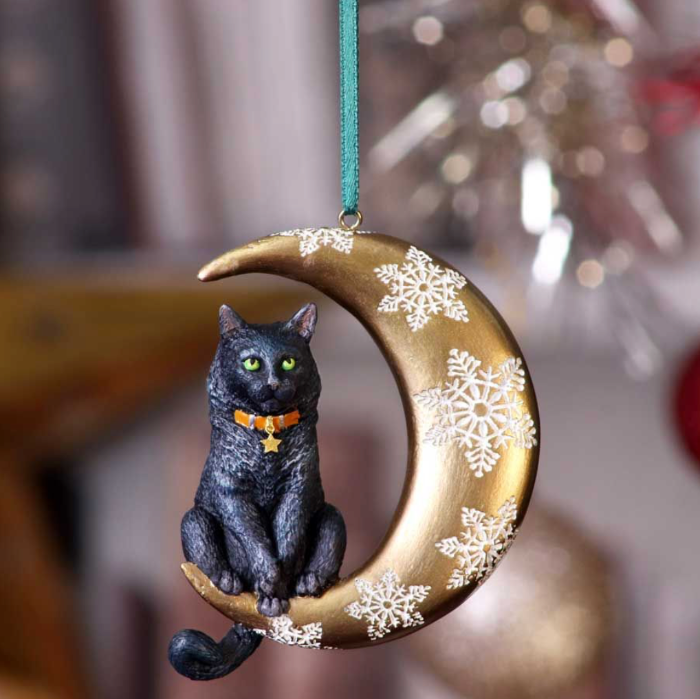 Black cat sitting on a golden crescent moon Christmas hanging ornament with white snowflakes