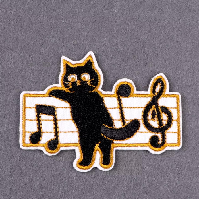 cat climbing on sheet music iron-on patch