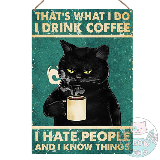 Metal wall sign with a black kitty drinking coffee and funny slogan ‘That’s What I Do - I Drink Coffee, I Hate People And I Know Things’. Just the perfect decoration to make you smile and brighten your home every day :)  Aluminium material, brushed silver colour back. Approx A4 sized, rounded corners