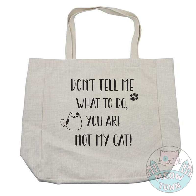 Funny and handy linen touch tote bag printed in the UK by us at Meow Town exclusively for You. 'Don’t tell me what to do, you are not my cat’ slogan with kitty and paw print. Natural beige bag colour. Durable