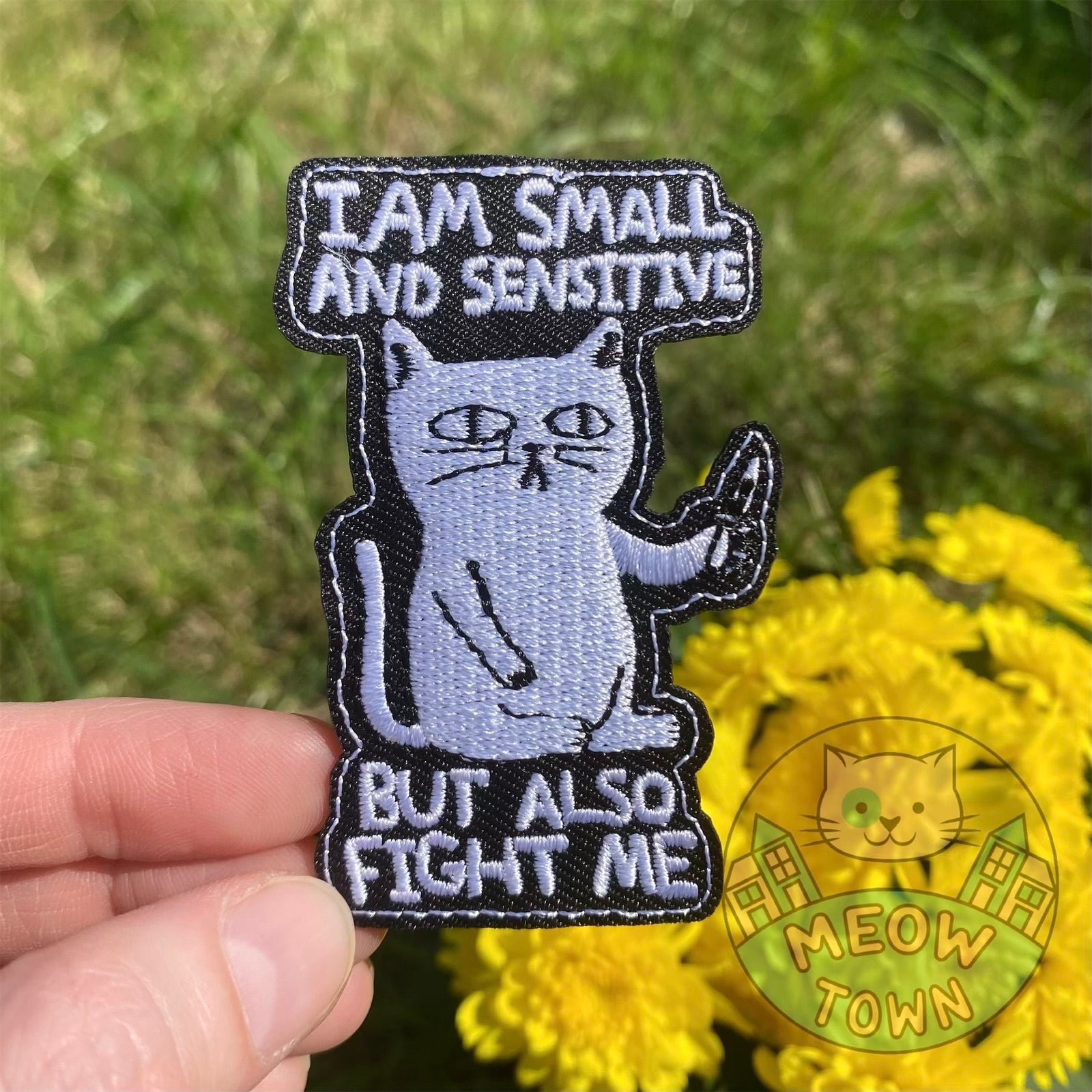 Cute embroidered iron-on cat patch with funny ‘I am small and sensitive but also fight me’ slogan. A perfect way to bring new life to your old garments or to cover small holes or marks with this cute patch!