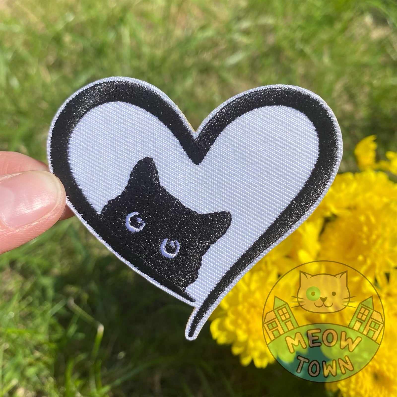 Adorable embroidered iron-on patch with a black kitty in a heart. A perfect way to bring new life to your old garments or to cover small holes or marks with this cute kitty!