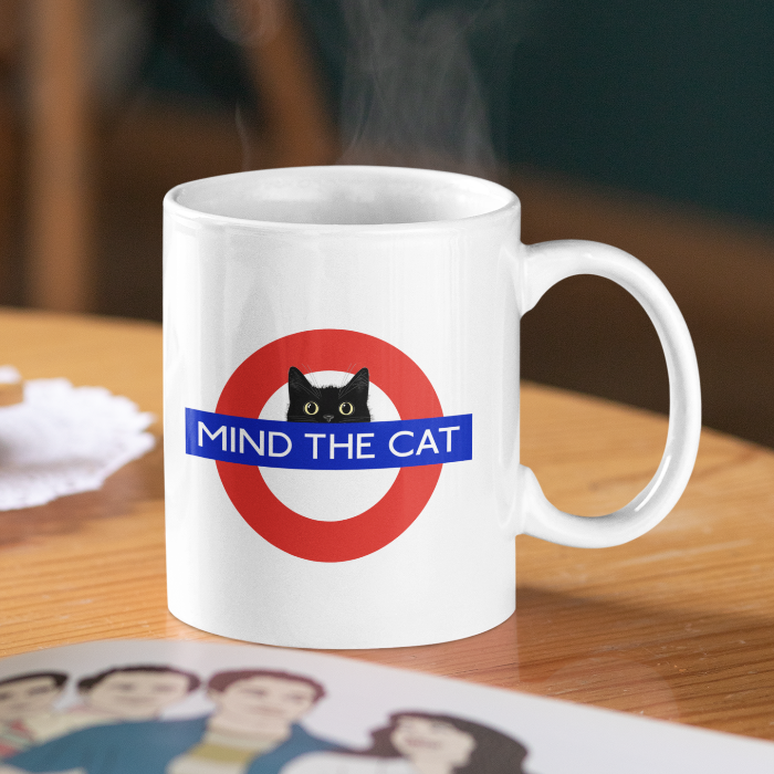 mind the cat tube mug white ceramix with hot coffee
