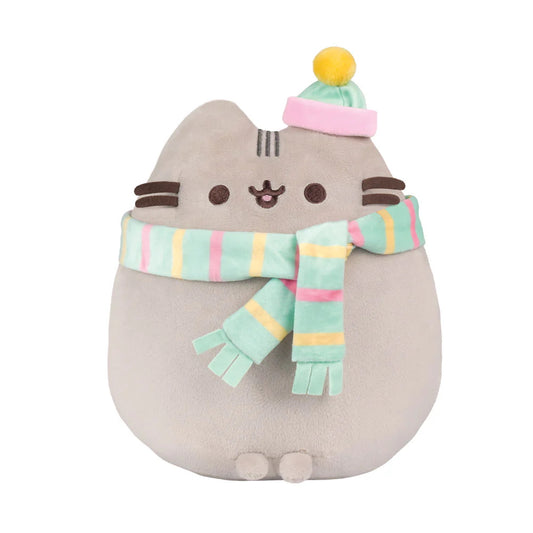 Adorable cuddly Pusheen soft toy with embroidered details and a super cute scarf and hat. Pusheen is a sweet, curious, lazy, &amp; plump tabby cat that loves to have adventures. Her hobbies include blogging