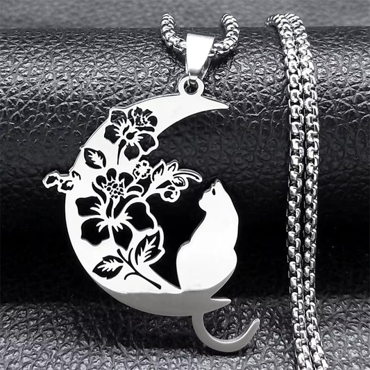 steel cat delicately perched on a crescent moon, adorned with intricate floral motif