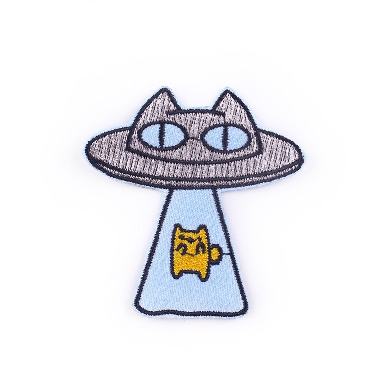 Cute embroidered iron-on patch with a kitty and a UFO :). Dimensions: 7 cm x 6.5 cm.  Glue is already applied to the back of the design, you can simply iron these patches on to the fabric. Perfect way to bring new life to your garments or bags