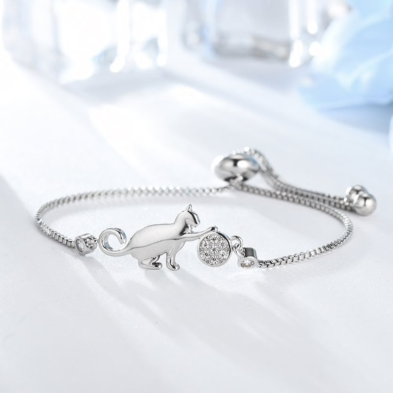 Beautiful bracelet with a small kitty playing with a crystal ball. Adjustable size, max perimeter is 23cm. Material: cubic zirconia, crystals. Silver colour. It can also be a lovely present for your cat lover friends and family