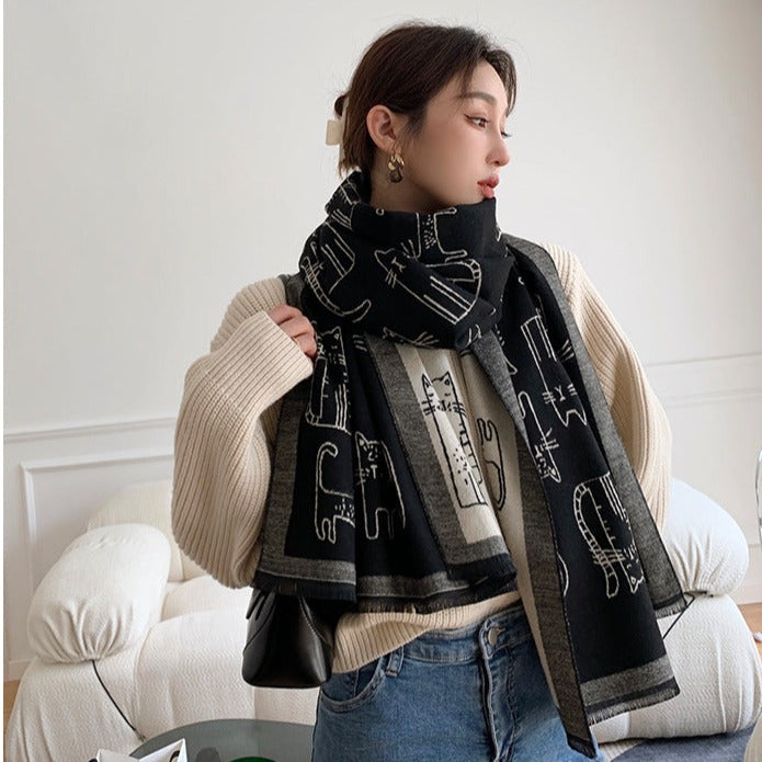Beautiful, warm and soft knitted scarf with kitty patterns all over.  Just the purrfect final touch to your outfit for the chilly season. Black and grey colours. 100% viscose material. A must have for all cat ladies, it can also be a great gift idea for your friends and family.