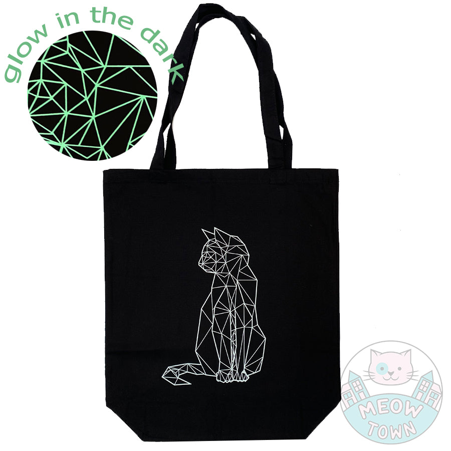 Meow Town Special, designed and printed in the UK by our team exclusively for You. Stylish geometric kitty design with glow-in-the-dark vinyl print. Off-white print colour which glows green when it's dark (when previously exposed to natural or synthetic light). 100% cotton heavy duty black canvas tote bag.