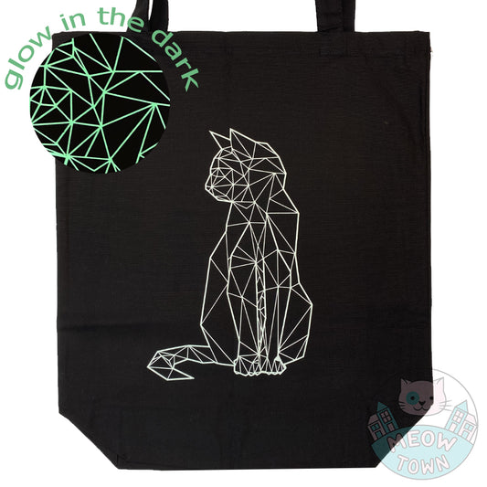 Meow Town Special, designed and printed in the UK by our team exclusively for You. Stylish geometric kitty design with glow-in-the-dark vinyl print. Off-white print colour which glows green when it's dark (when previously exposed to natural or synthetic light). 100% cotton heavy duty black canvas tote bag.