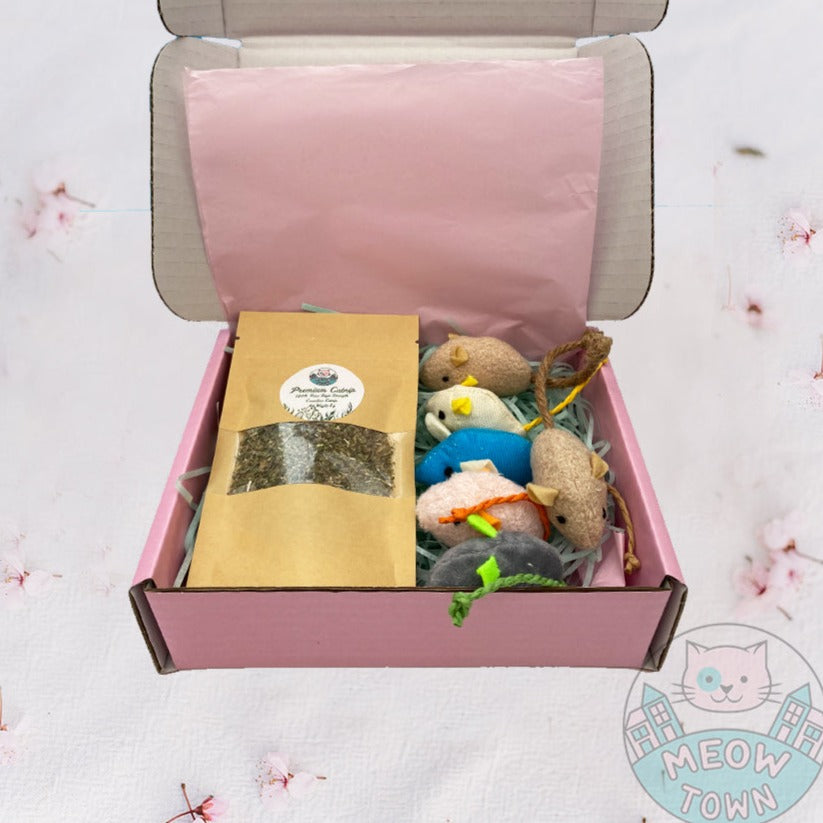 A cute gift box for cats in lovely presentation box. The gift box includes: -6pcs mice with catnip -5g extra strong Meow Town catnip  The box features two white kitty shaped cardstock stickers on the front