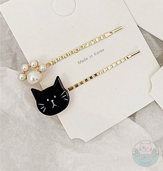 Cat hairpins set of 2, with a cat and pearl paw design black white gold colours