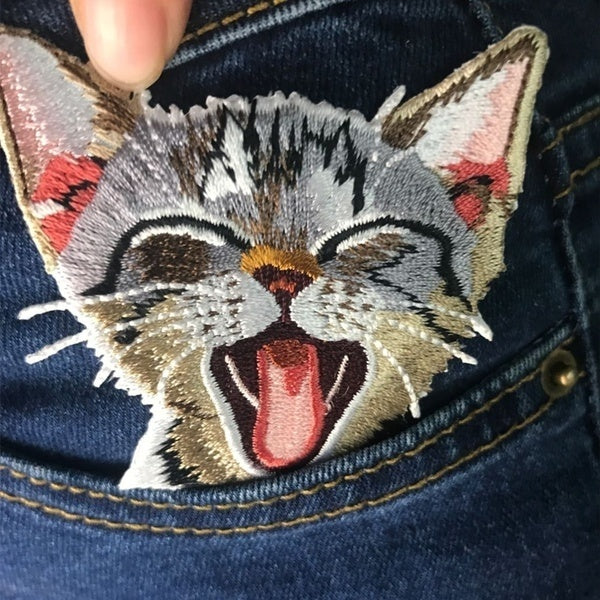 Adorable embroidered iron-on kitty patches in various designs.  A perfect way to bring new life to your old garments or cover small holes or marks with these cute kittens! Please choose required design from the drop-down menu. Glue is already applied to the back of the design, you can simply iron these patches on to the fabric 
