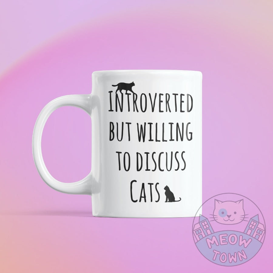 Funny 'Intorverted but willing to discuss cats' slogan ceramic mug, from our Meow Town Special collection. Printed exclusively for You in the UK in-house by us. Funny and unique present for your cat lover friends and family. 