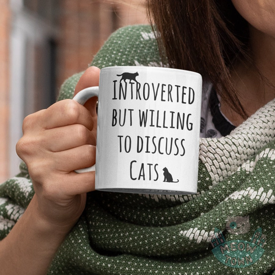 Funny 'Intorverted but willing to discuss cats' slogan ceramic mug, from our Meow Town Special collection. Printed exclusively for You in the UK in-house by us. Funny and unique present for your cat lover friends and family. 