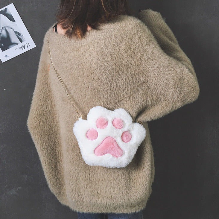 Paw shaped, fluffy crossbody zipped purse. Faux fur (polyester) fabric and gold colour metalware. Suitable for small sized items such as keys, medium sized phone, tissue, coins, makeup.