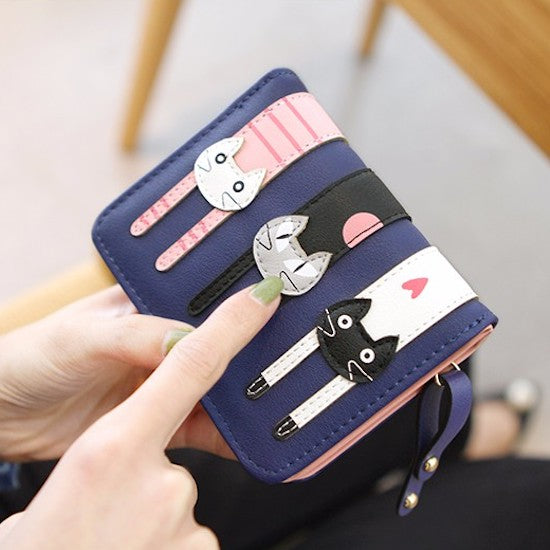 A beautiful and unique small purse with three adorable kitties. Features card holder sleeves and zip-around coin pocket. feline themed wallet for cat ladies
