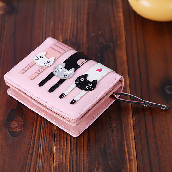 A beautiful and unique small purse with three adorable kitties. Features card holder sleeves and zip-around coin pocket. feline themed wallet for cat lovers