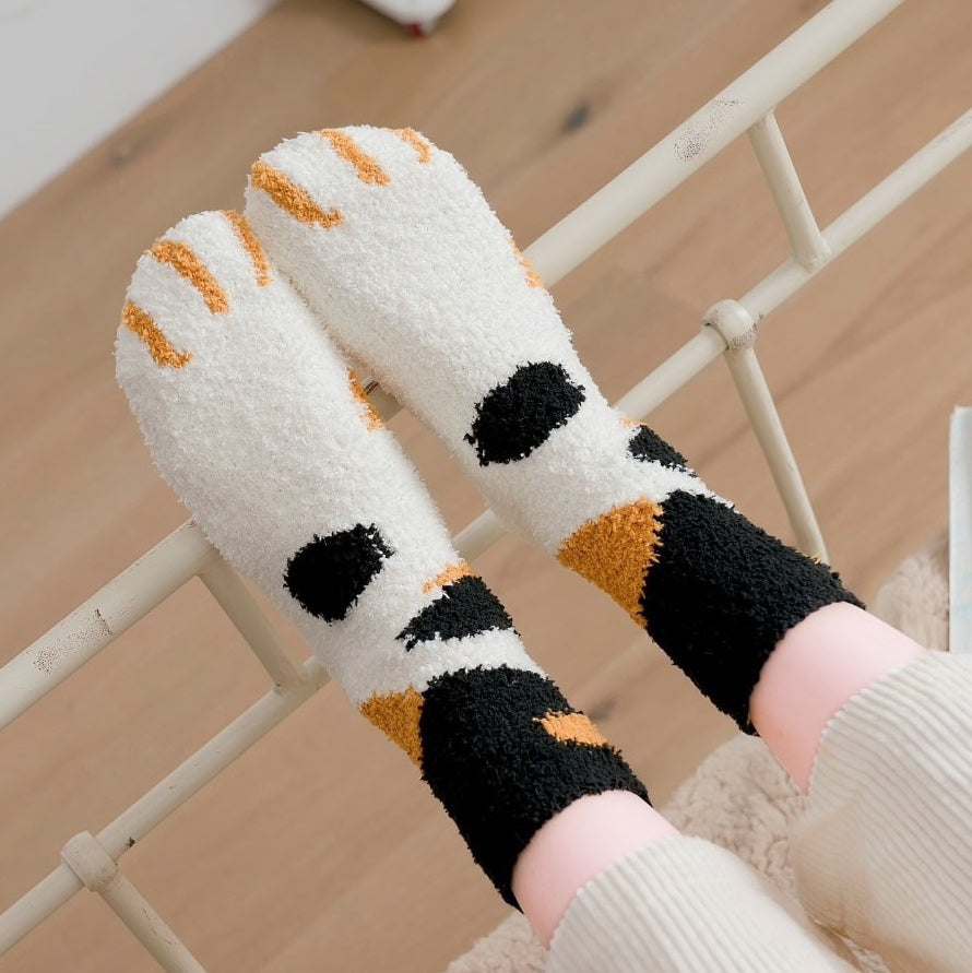 A pair of lovely, warm socks to match your footsies to your little furry friend's paws.  Soft and very comfy.  One size calico design