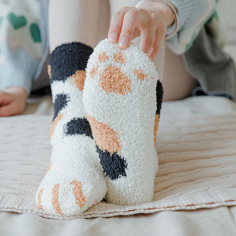A pair of lovely, warm socks to match your footsies to your little furry friend's paws.  Soft and very comfy.  One size calico paw pattern