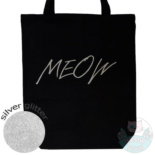 Meow Town Special, designed and printed in the UK by our team exclusively for you. Cute 'Meow' slogan with silver colour glitter print. 100% cotton heavy duty black canvas tote bag. Durable single layer material, large capacity.